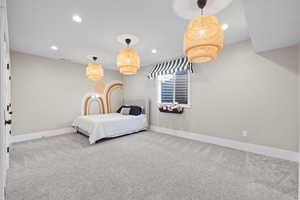 Carpeted bedroom with baseboards and recessed lighting