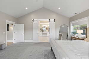 Carpeted bedroom featuring a barn door, recessed lighting, visible vents, baseboards, and high vaulted ceiling