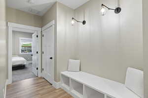 Mudroom featuring baseboards, visible vents, and light wood-style flooring