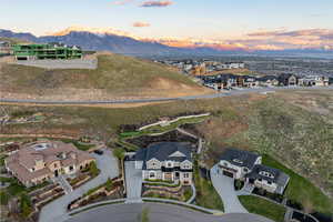Aerial view at dusk featuring a mountain view and a residential view