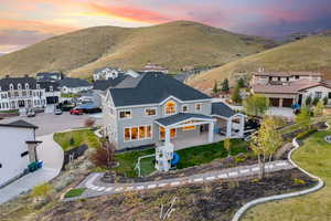 Aerial view at dusk featuring a mountain view and a residential view
