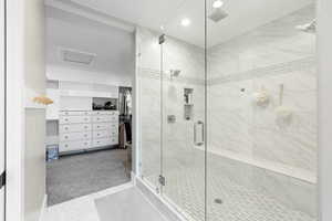 Full bath with a walk in closet, visible vents, a stall shower, and recessed lighting