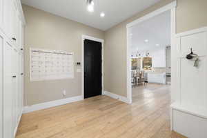 Foyer entrance featuring recessed lighting, light wood-style flooring, and baseboards