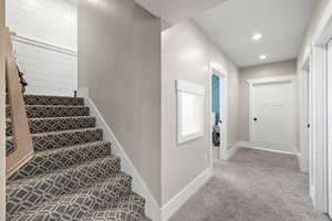 Stairs featuring baseboards, carpet flooring, and recessed lighting