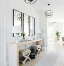 Interior space featuring light wood-type flooring, baseboards, and a chandelier