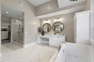 Bathroom with baseboards, visible vents, a jetted tub, a shower stall, and vanity