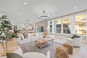 Living area featuring an inviting chandelier and recessed lighting