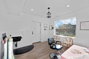 Home office with plenty of natural light, visible vents, light wood finished floors, and recessed lighting