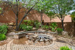 View of patio / terrace featuring fence and an outdoor fire pit