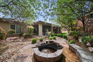Rear view of house featuring a patio, an outdoor fire pit, and stucco siding