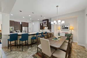 Dining space with baseboards, recessed lighting, and a chandelier