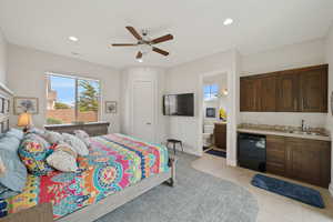 Bedroom featuring a sink, baseboards, recessed lighting, connected bathroom, and light tile patterned floors