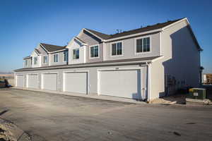 Exterior space featuring concrete driveway and a garage