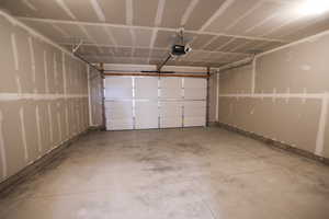 Garage featuring a garage door opener