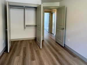 Bedroom 1 Unfurnished bedroom with a closet, wood finished floors, and a textured ceiling