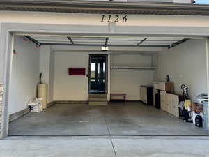 Garage featuring concrete driveway