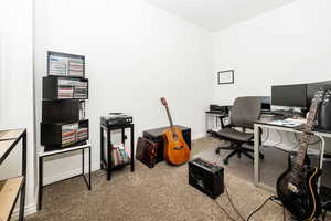 Home office featuring baseboards and carpet floors
