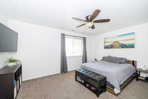 Bedroom with baseboards, carpet flooring, and ceiling fan