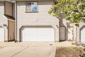 View of front of property featuring concrete driveway and a garage