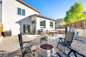 View of patio / terrace with a fenced backyard, a mountain view, central air condition unit, and a hot tub