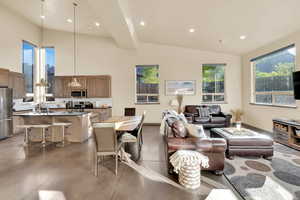 Living area with concrete flooring, and recessed lighting