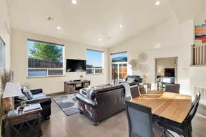 Living room with vaulted ceiling and recessed lighting