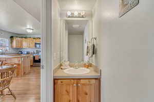 Bathroom featuring wood finished floors, a textured ceiling, and vanity