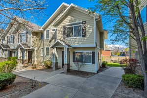 View of front of home featuring fence
