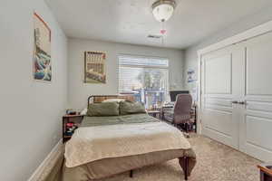 Bedroom featuring baseboards, visible vents, and carpet flooring