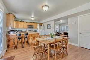 Dining area with light wood-type flooring and baseboards