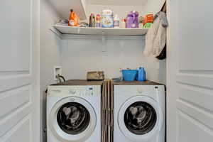 Washroom featuring laundry area and independent washer and dryer