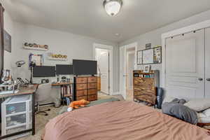 Bedroom featuring light carpet and baseboards