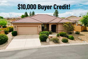 Mediterranean / spanish home with a garage, stucco siding, driveway, and a tiled roof