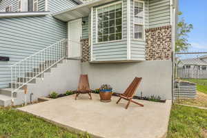 Entrance to property featuring fence and a patio