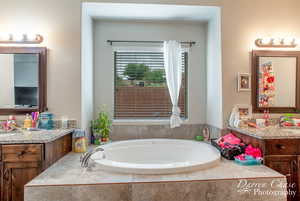Full bath with a garden tub and vanity