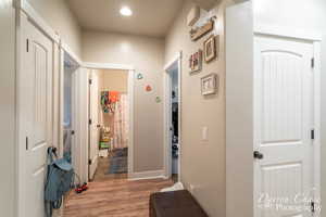 Hall with recessed lighting and light wood-type flooring