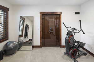 Exercise area or bedroom with safe door.