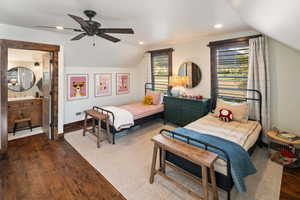 Bedroom featuring dark wood finished floors, lofted ceiling, a sink, and recessed lighting
