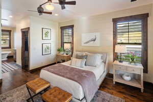 Bedroom featuring wood finished floors and multiple windows