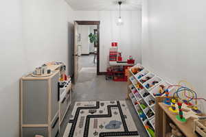 Recreation room with concrete flooring