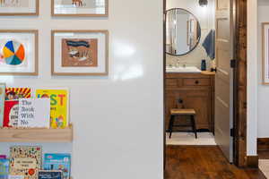 Bathroom with wood finished floors and vanity