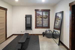 Workout area featuring recessed lighting, electric panel, and baseboards or possible bedroom