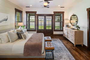 Bedroom featuring visible vents, baseboards, dark wood-style flooring, and french doors