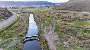 Aerial view of property's location with a water and mountain view and a notable bridge