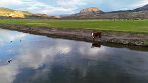 Water view with a mountain backdrop and rural landscape