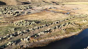 Aerial overview of property's location featuring rural landscape and a large body of water