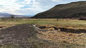 View of mountain backdrop with rural landscape