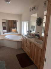 Full bathroom with double vanity and a bath