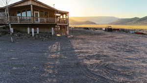 Rear view of property featuring a mountain view and stairs