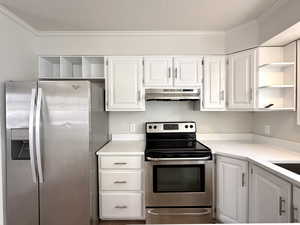 Kitchen with open shelves, appliances with stainless steel finishes, under cabinet range hood, and white cabinets